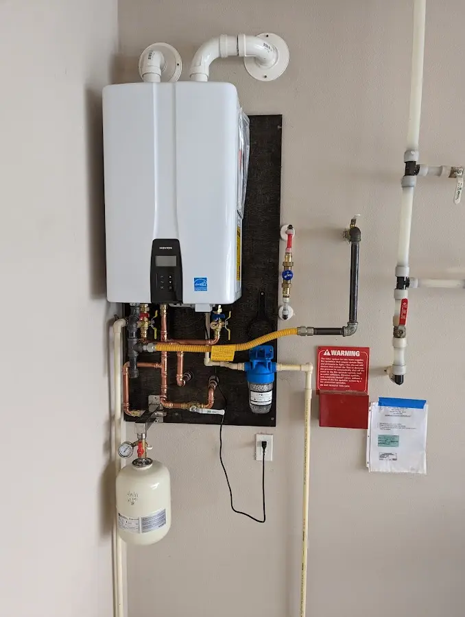 Professional plumber installing copper piping in a National Park home